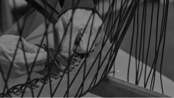 Black-and-white close-up of the parachute cords on a Crosshatch lounge chair.