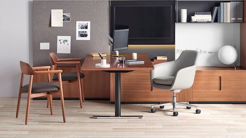 An executive office featuring Geiger Rhythm Casegoods, a light gray Saiba office chair, and two Crosshatch Side Chairs with black leather seat pads.