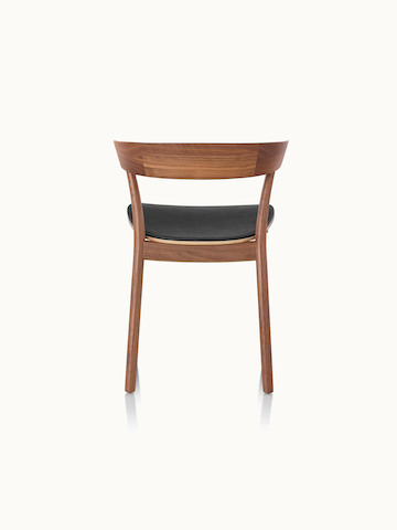 A Leeway side chair with a wood frame and backrest in a medium finish and a seat upholstered in black leather, viewed from behind.