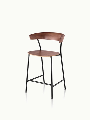 Angled view of a counter-height Leeway Stool with a metal frame and a wood backrest and seat in a medium finish.