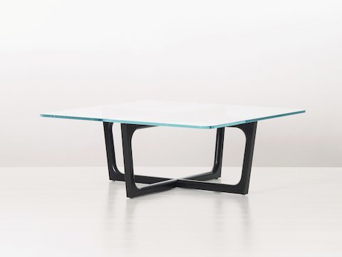 A rectangular Loophole coffee table with a 30-inch-deep glass top and black wood base, viewed at an angle.