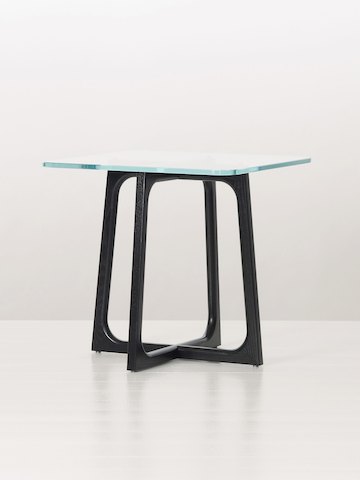 A square Loophole side table with a glass top and black wood base, viewed at an angle.
