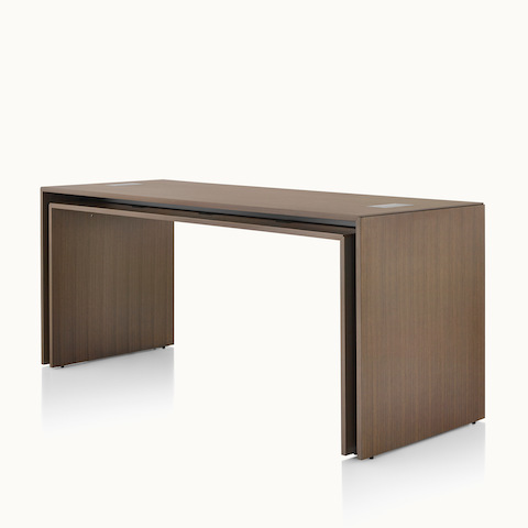 Angled view of a rectangular Peer Table in a dark wood finish. Select to go to the Peer Tables product page.