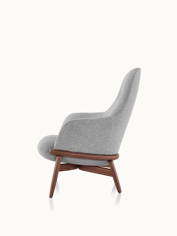 Side view of a high-back Reframe lounge chair with light gray upholstery and a wood frame in a medium finish.