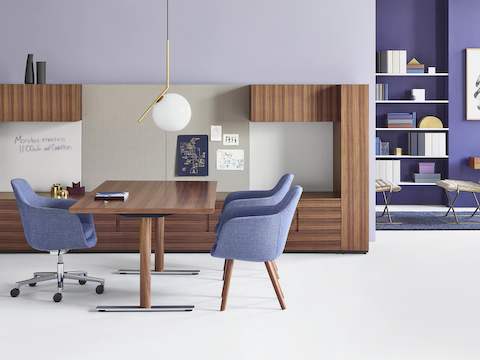An executive office featuring Geiger Rhythm Casegoods, a light blue Saiba office chair, and two light blue Saiba Side Chairs.