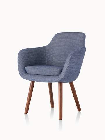 Angled view of a Saiba Side Chair with blue upholstery and wood legs in a medium finish.