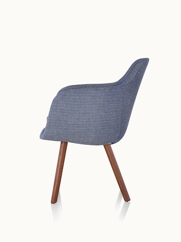 Side view of a Saiba Side Chair with blue upholstery and wood legs in a medium finish.
