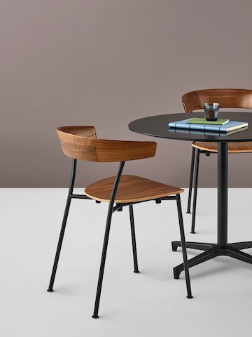 Two Leeway side chairs complement a black Saiba occasional table with a round top.