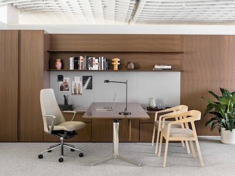 An executive office featuring Geiger Levels Casegoods, a beige leather Taper office chair, and two Full Twist Guest Chairs.