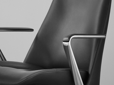 Angled view of the seat, arms, and back of a black leather Taper office chair.