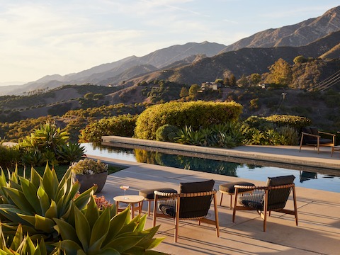 Crosshatch Outdoor Lounge Chairs with Ottomans in an environmental setting by the pool.