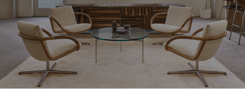 Four Full Loop Lounge Chairs around a glass and metal Claw Table in front of a Domino Credenza in an office lounge setting. Four Full Loop Lounge Chairs around a glass and metal Claw Table in front of a Domino Credenza in an office lounge setting.