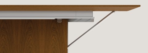 Partial view of the top and underside of a Caucus Table with a medium wood finish.