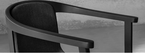 Lijn Chair designed by Carole Baijings for Geiger with upholstered seat and back and tinted wood frame in Red Clay viewed at an angle in a styled environment. Lijn Chair designed by Carole Baijings for Geiger with upholstered seat and back and tinted wood frame in Red Clay viewed at an angle in a styled environment.