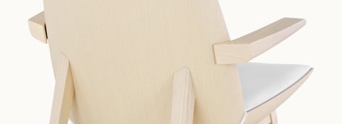 Partial rear view of a Clamshell Lounge Chair with a light wood finish. Partial rear view of a Clamshell Lounge Chair with a light wood finish.