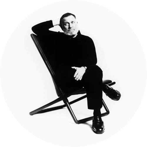 Product designer Ward Bennett seated on a Sled Chair.
