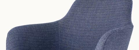 Partial view of a Saiba Lounge Chair with blue fabric.