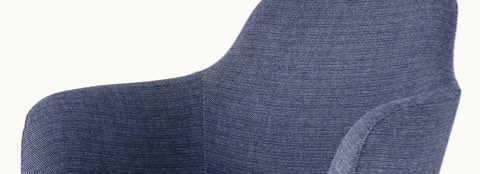 Partial view of a Saiba Lounge Chair with blue fabric. Partial view of a Saiba Lounge Chair with blue fabric.