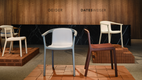 Lijn Side and Armchairs designed by Carole Baijings for Geiger in assorted finishes shown front-facing on an exhibition platform in the Geiger DatesWeiser showroom in Chicago.
