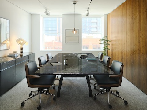 Ascent Conference Table in Nero Marquina Marble and Credenza in Ebonized Oak by DatesWeiser, both designed by EOOS, with Geiger Clamshell Chairs designed by BassamFellows shown in a meeting room in the Geiger DatesWeiser Chicago Showroom.