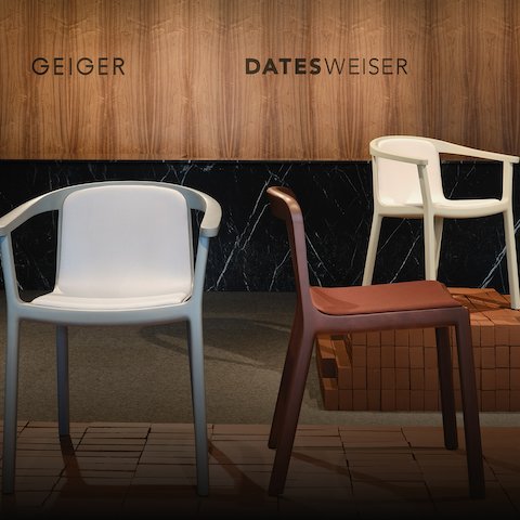 Lijn Side and Armchairs designed by Carole Baijings for Geiger in assorted finishes shown front-facing on an exhibition platform in the Geiger DatesWeiser showroom in Chicago.