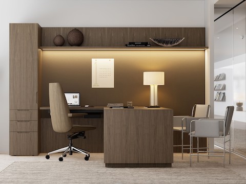 A Geiger One Private Office in Natural Flat Cut Walnut with a Clamshell Office Chair and Envelope Guest Chairs viewed from the side.