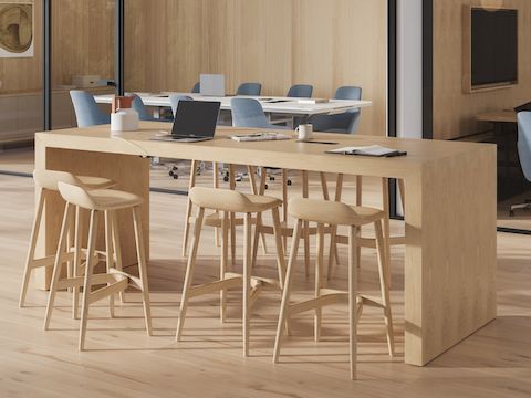 JD Waterfall Table by DatesWeiser meeting table in Oak with Crosshatch Stools and conference rooms in the background.