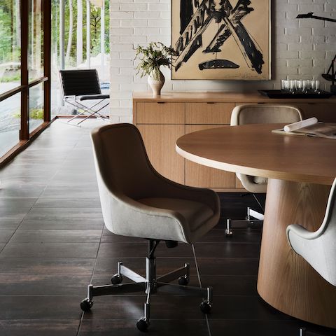 JD Meeting Table for DatesWeiser in natural flat cut oak shown with by Bumper Chairs in front of a Highline 25 Credenza with a Sled Chair in the background.