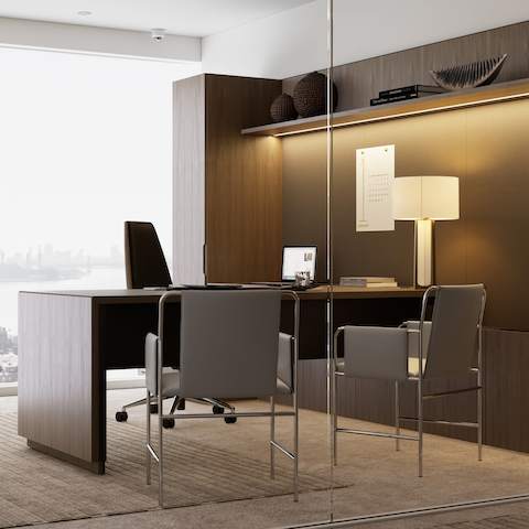 A Geiger One Private Office in Natural Flat Cut Walnut with a Clamshell Office Chair and Envelope Guest Chairs viewed from an angle.