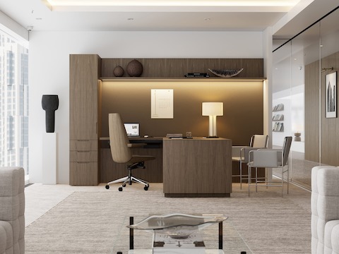 A Geiger One Private Office in Natural Flat Cut Walnut with a Clamshell Office Chair and Envelope Guest Chairs viewed from the side.