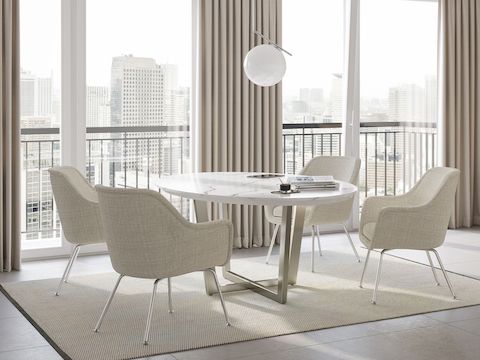 Private office with Geiger One sit-to-stand desk and Bumper Chair to the right of a meeting table surrounded by four Bumper Side Chairs.