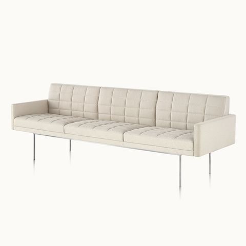 Tuxedo Component Lounge Sofa upholstered in a light textile with metal legs, viewed from an angle. 