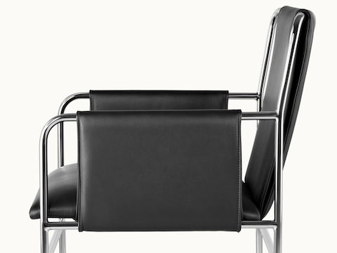 Side view of an Envelope side chair with black leather upholstery and a tubular steel frame.