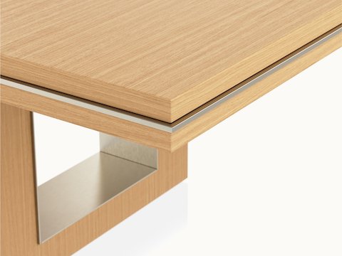 Edge detail shot of a Rectangular Highline Fifty Conference Table by DatesWeiser in Natural Rift Cut Oak with a Satin Nickel edge and base trim.