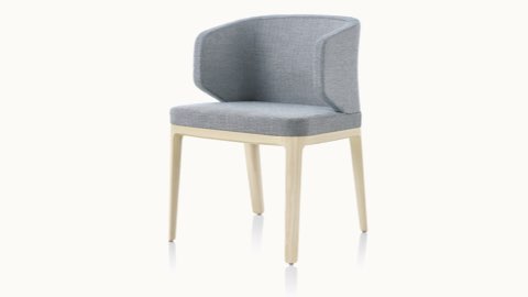 Angled view of a wingback A Line side chair with light gray upholstery. Angled view of a wingback A Line side chair with light gray upholstery.
