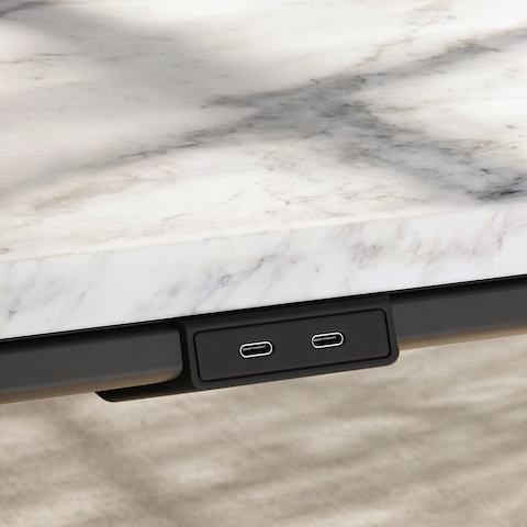Detail of Ascent Conference Table by EOOS for DatesWeiser showing edge power access in White Carrara marble with natural rift cut oak base viewed at an angle.