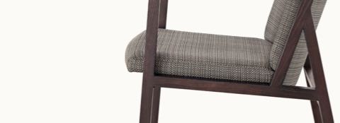 Close side view of the middle portion of an Ascribe side chair, showing wood frame detail.