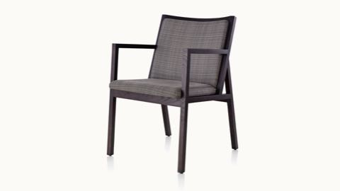 Angled view of an Ascribe side chair with gray upholstery and a wood frame in a dark finish.