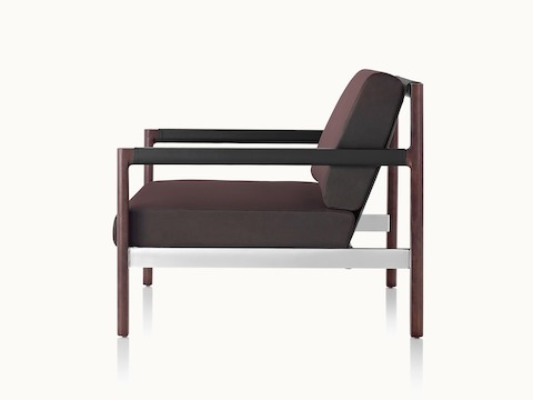 Side view of a Brabo club chair with dark brown upholstery, leather and metal accents, and an exposed wood frame.