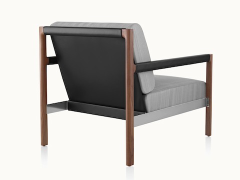 A Brabo club chair, viewed from behind to show the black leather sling and arm wrap.
