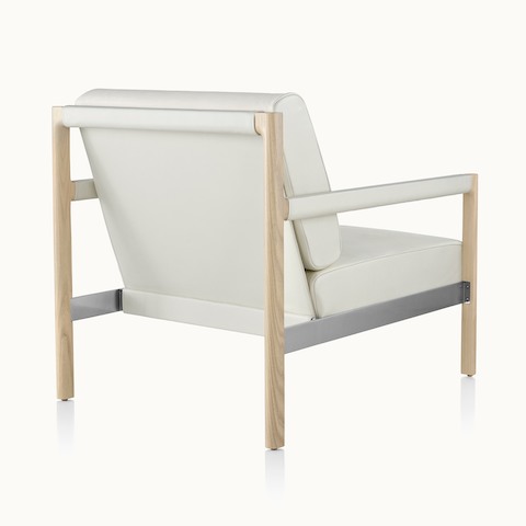 A Brabo club chair with off-white leather upholstery, viewed from behind to show the exposed wood and metal frame.