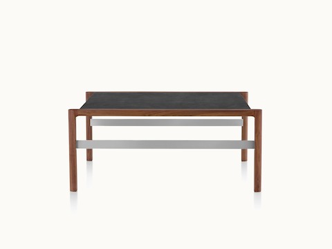Partial front view of a rectangular Brabo coffee table with a black leather-wrapped top, walnut lower shelf, and metal frame supports.