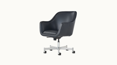 Angled view of a Bumper side chair with light gray fabric upholstery and a four-leg base. Angled view of a Bumper side chair with light gray fabric upholstery and a four-leg base.