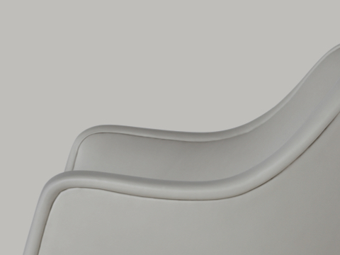 Partial side view of a Bumper Chair, focusing on the curved arms. Partial side view of a Bumper Chair, focusing on the curved arms.