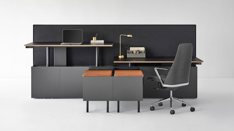 A two-pack Geiger One Casegoods bench system with accessorized workstations, one at standing height and the other at sitting height with a Taper Chair. Select to go to the Open Plan landing page.