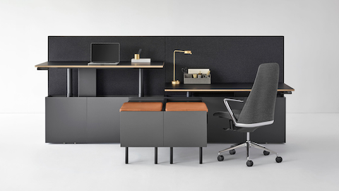 A two-pack Geiger One Casegoods bench system with accessorized workstations, one at standing height and the other at sitting height with a Taper Chair. Select to go to the Open Plan landing page.