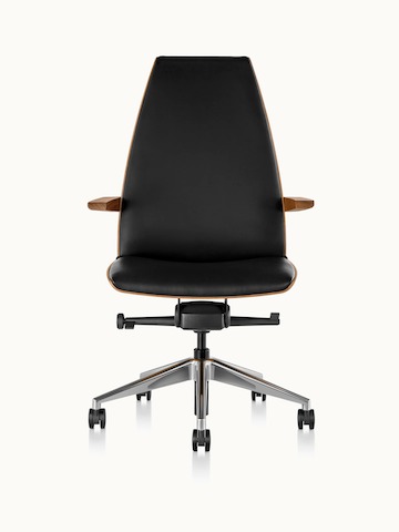 Side view of a high-back Clamshell office chair with arms, black leather upholstery, and a veneer shell in a medium finish.