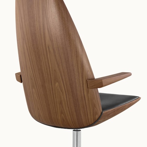 Back angle view of a Clamshell Lounge chair with black leather upholstery and walnut shell.