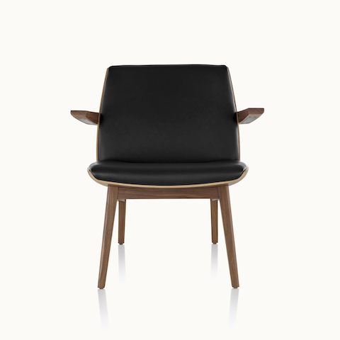 Front view of a low-back Clamshell Lounge Chair with black leather and walnut legs.