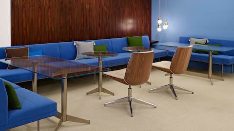 An informal interaction space featuring bright blue Tuxedo Component Lounge Seating and two Clamshell Side Chairs.